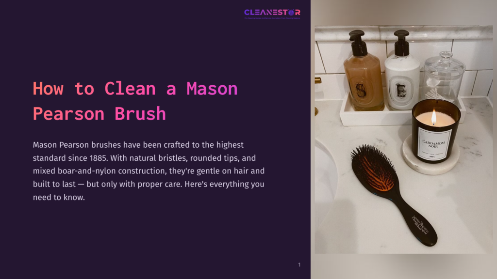 A Dark Mason Pearson Hairbrush With Boar Bristles And Nylon Pins Rests On A White Marble Countertop Next To A Lit &Quot;Cardamom Noir&Quot; Candle And Two Bottles Of Liquid Soap.