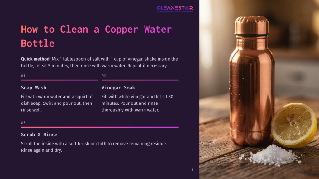 A Copper Water Bottle, A Half-Cut Lemon, And A Small Pile Of Salt Sit On A Wooden Surface. The Bottle Has A Copper Body And A Matching Cap, With A Label &Quot;Cleanest&Quot; In The Center. Nearby, A Glass Of White Vinegar And A Dish Soap Bottle Are Also Visible.