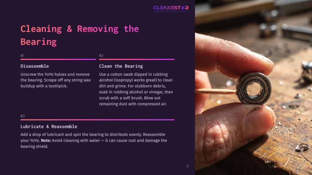 Close-Up Of A Person'S Hands Holding A Small, Silver Bearing. The Bearing Is Being Cleaned With A Toothpick, With Dust And Debris Visible On A Wooden Surface In The Background.