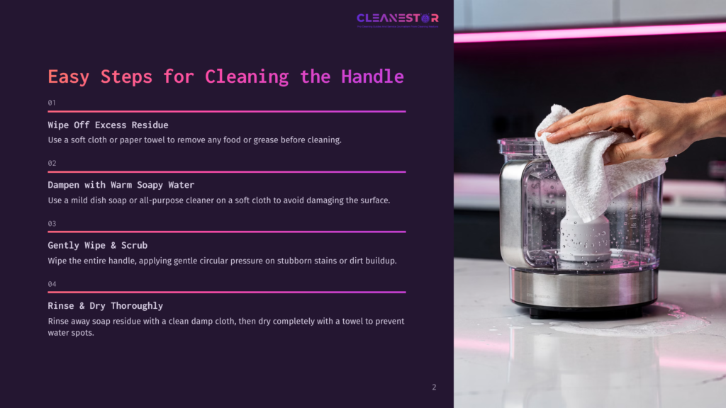 Close-Up Of A Hand Wiping A Food Processor Bowl With A White Cloth, Showing Cleaning Steps For The Handle.