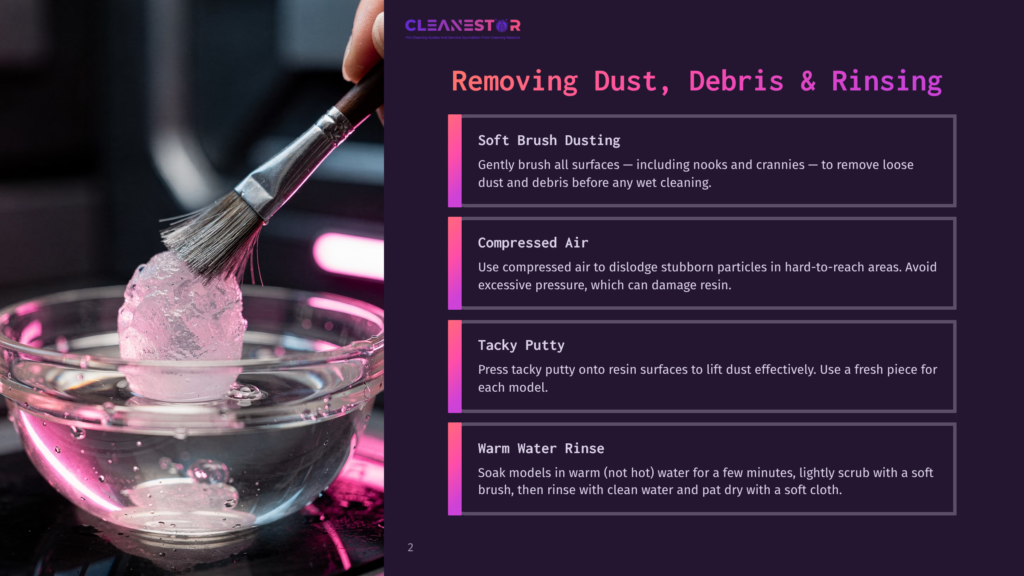 A Soft Brush With A Large Glob Of Clear, Sticky Putty Is Held Over A Glass Bowl Filled With Pink-Tinted Water. The Image Is Part Of A &Quot;Cleanestor&Quot; Guide On Removing Dust, Debris, And Rinsing.