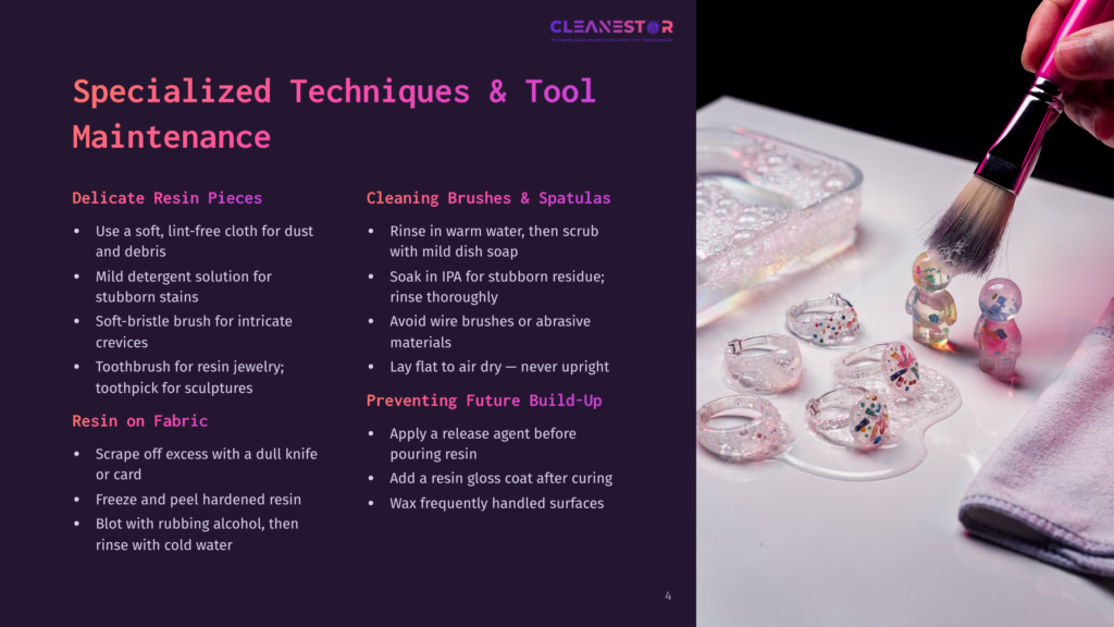 A Hand Holding A Pink Paintbrush Applies Paint To Delicate Resin Pieces On A White Surface, Next To Cleaning Brushes And Spatulas, With A Background Of Resin Art, Including A Glass Tray And Various Tools.