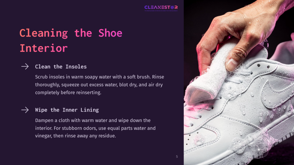 Close-Up Of A Hand Holding A White Cloth, Gently Cleaning A White Sneaker With Soap Suds And Water Droplets. The Background Is Dark And Out Of Focus, Highlighting The Shoe Cleaning Process.