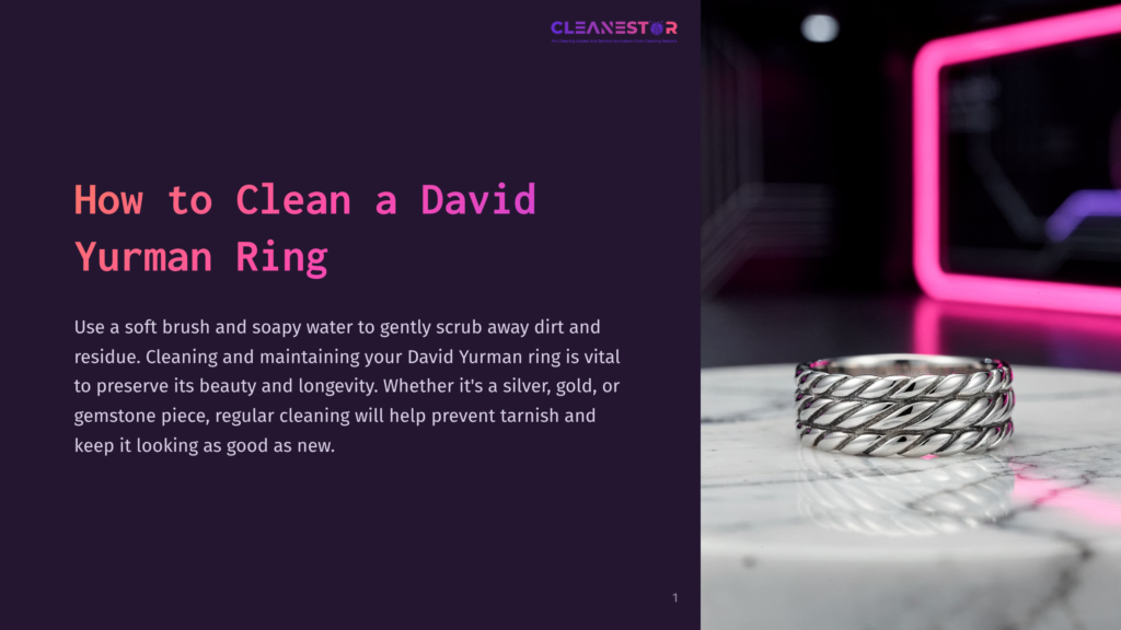 A Silver David Yurman Ring Resting On A Marble Surface, With A Dark Purple Background And Bright Pink Accents In The Layout.