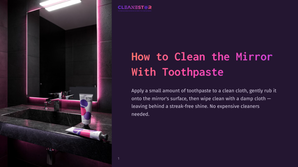 A Modern Bathroom With A Dark Granite Sink, A Mirror Illuminated By Pink Lights, And A Tube Of Toothpaste On The Counter.