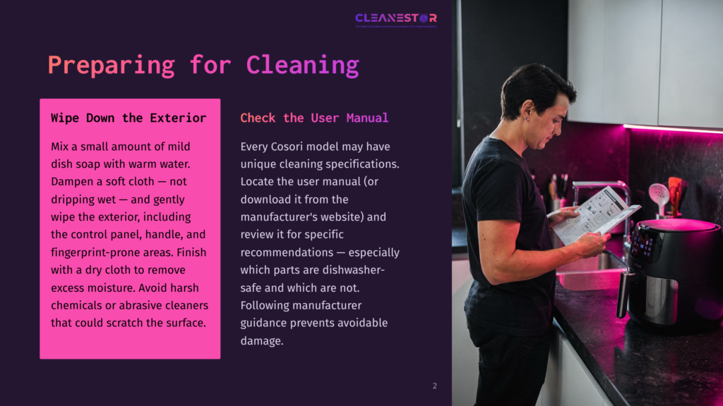 A Person Reads A User Manual While Standing Next To A Cosori Air Fryer, With A Pink And Black Color Scheme In A Kitchen Setting.