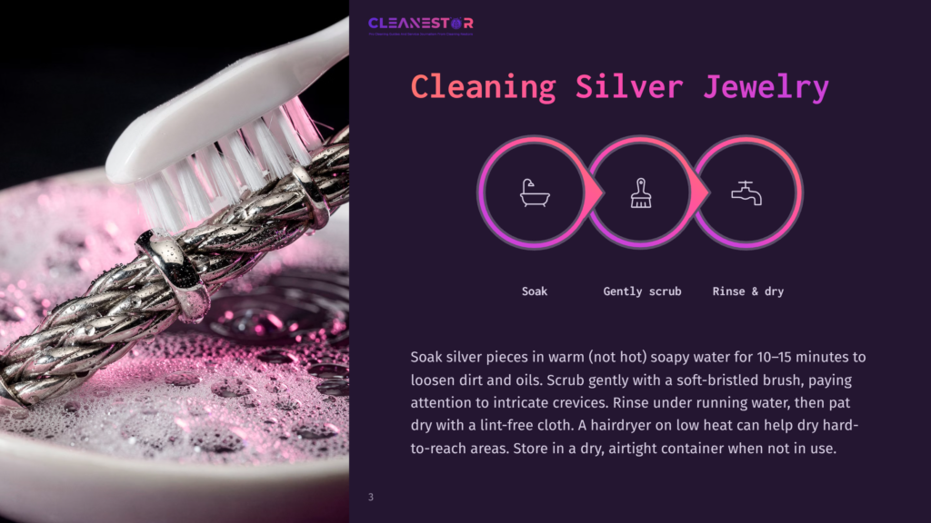 A Close-Up Of A Silver Jewelry Piece Being Scrubbed With A Toothbrush In Soapy Water, Surrounded By Bubbles And A Purple Background.