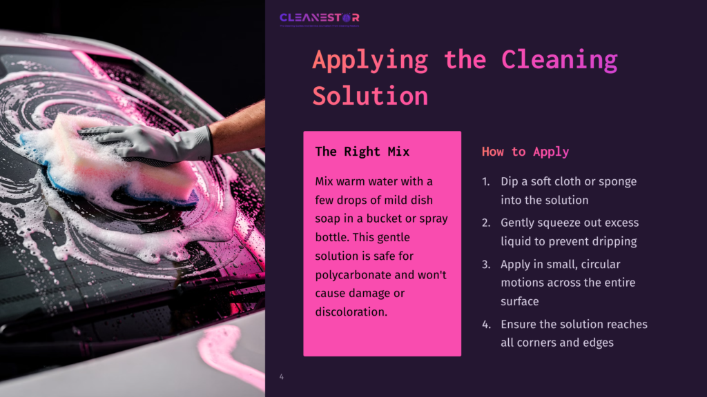 A Hand Cleaning A Polycarbonate Windshield With A Cloth, Pink Cleaning Solution, And Soap Bubbles On A Dark Background.