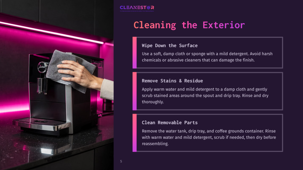 Close-Up Of A Hand Wiping The Exterior Of A Black Jura Coffee Machine With A Gray Microfiber Cloth, Against A Dark Background With Vibrant Pink Lighting.