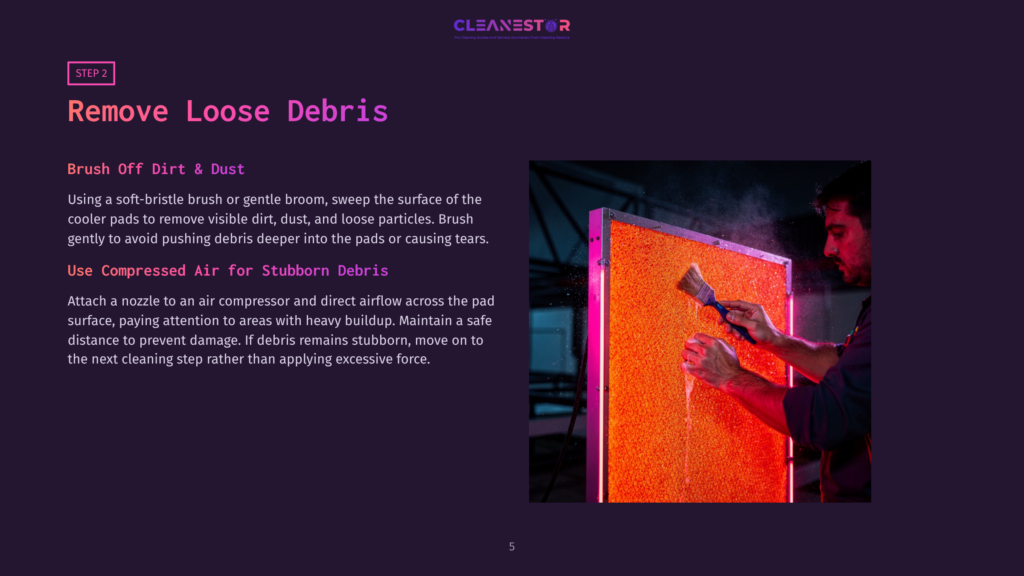 5 Remove Loose Debris Man Uses A Blue Brush To Clean An Orange, Textured Cooler Pad, Removing Loose Debris. The Pad Is Illuminated By Pink Led Lights.