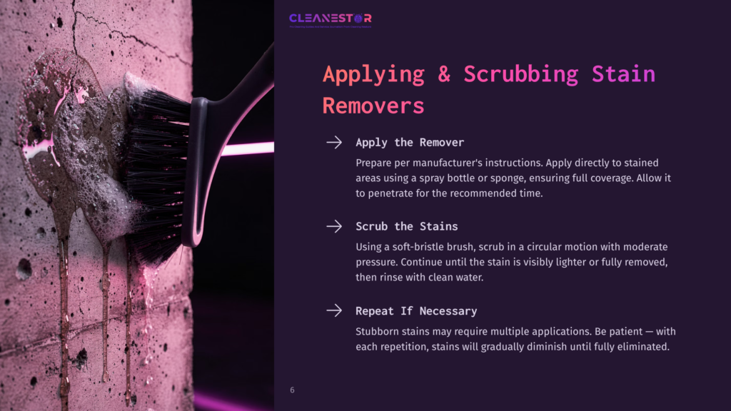 Close-Up Of A Black Scrubbing Brush With White Foam Being Applied To A Textured Concrete Wall, With Pink Light Illuminating The Scene And Text Overlay &Quot;Applying &Amp; Scrubbing Stain Removers&Quot;.