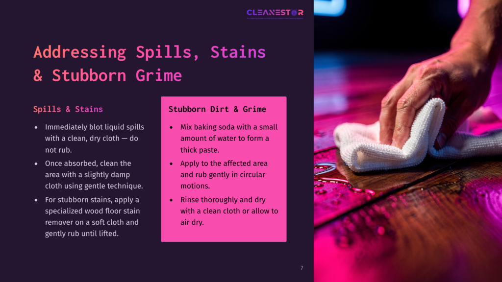 Close-Up Of A Hand In A White Cloth Wiping Up A Spill On A Dark Wooden Floor With Pink And Purple Lighting.
