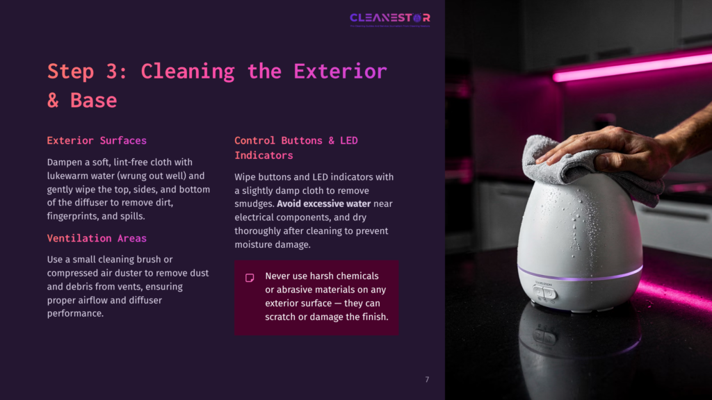 A Person Wipes The Exterior Of A White Aroma 360 Diffuser With A Cloth, Showing Control Buttons And A Soft Glow From Led Indicators.