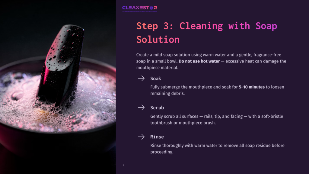 7 Step 3 Cleaning With Soap Solution Close-Up Of A Black Mouthpiece With A Shiny Finish Being Cleaned In A Bowl Of Soapy Water. Bubbles And Foam Cover The Mouthpiece And The Water'S Surface, Indicating The Cleaning Process.