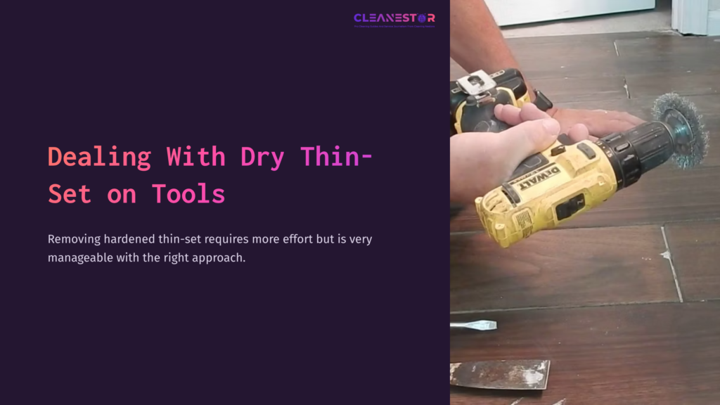 Close-Up Of Hands Using A Yellow Power Drill With A Wire Brush Attachment, Focused On Removing Dried Thin-Set From A Tool On A Wooden Surface.